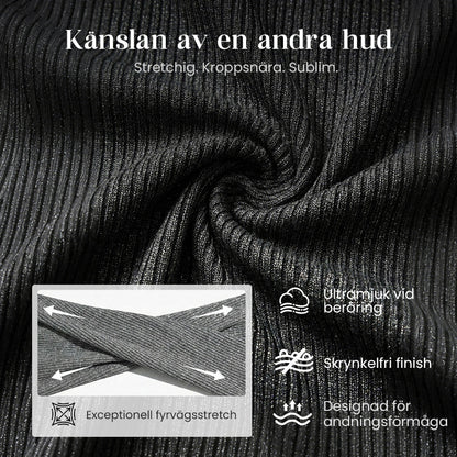 Damklänning med dragkedja, slag och förlängda ärmar i stickat material, med fiskstjärtkant.
