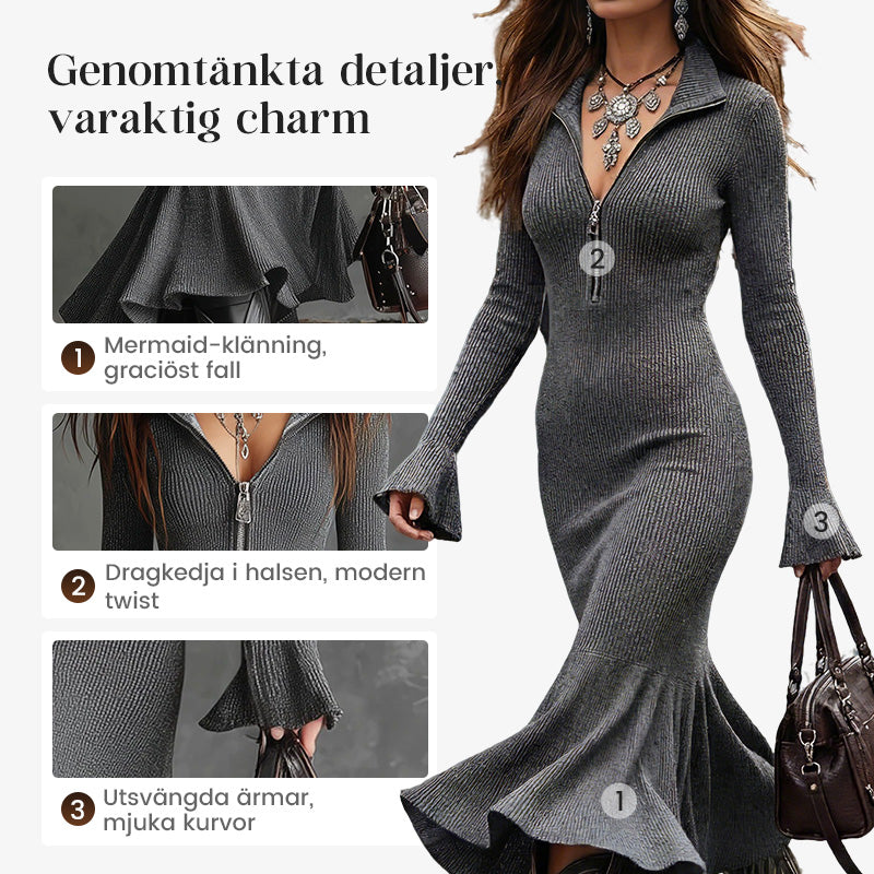 Damklänning med dragkedja, slag och förlängda ärmar i stickat material, med fiskstjärtkant.