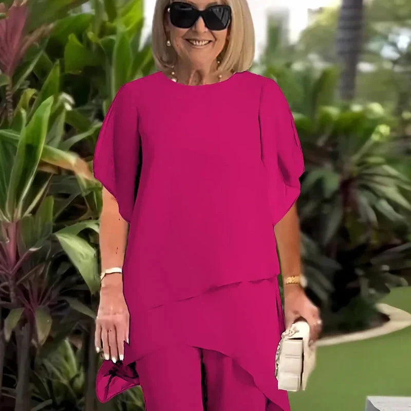 Damset i två delar: Snygg asymmetrisk topp och vida byxor