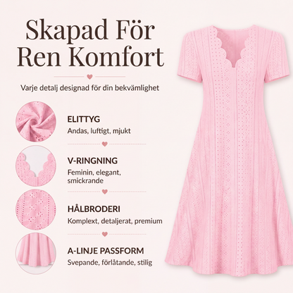 Damklänning med bågformad v-ringning och hålsömmar